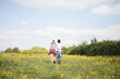 © Fergus Coyle - Young couple walking in a field
