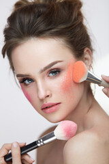 Wall Mural - face beauty cosmetics. beautiful girl with makeup applying blush