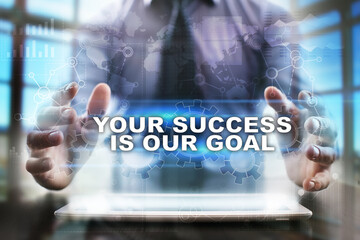 Businessman using tablet pc and selecting your success is our goal.