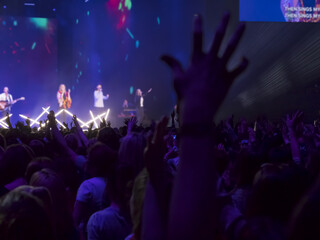 People partying at a concert and enjoying live music.