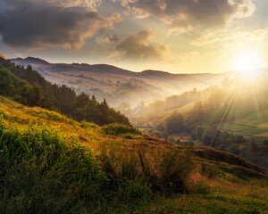 foggy hillside in rural area at sunset