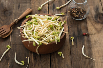 Wall Mural - Bowl with Mungbean Sprouts on wooden background

