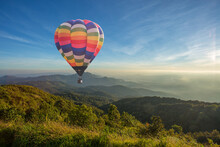 Colorful Hot Air Balloon Over The Mountain At Sunset