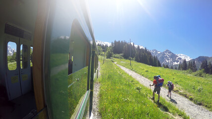 MONT BLANC, FRANCE - circa JUL, 2017: POV from Old fashioned Montblanc tramway to two hikkers. Nid d'Aigle the is last station Mont Blanc Tramway at 2386 meters in Chamonix, France