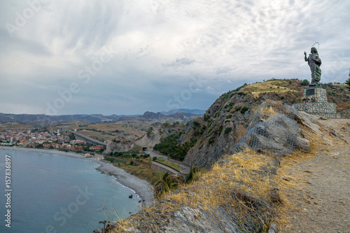 Fotografie, Obraz Madonna del Mare (Our Lady of the Sea) statue and Bova Marina Town aerial view -