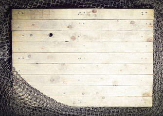 Fishing nets still-life on the wooden background.