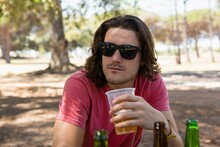 Man In Sunglasses Having A Beer In The Park