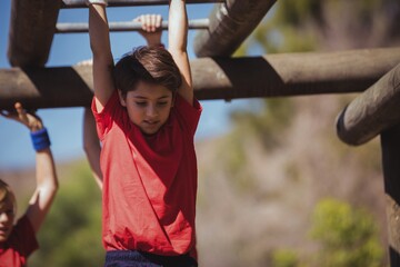Wall Mural - kids climbing horizontal bars during obstacle course training