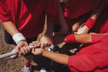 Wall Mural - kids playing tug of war during obstacle course training