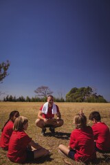 Wall Mural - trainer instructing kids in the boot camp