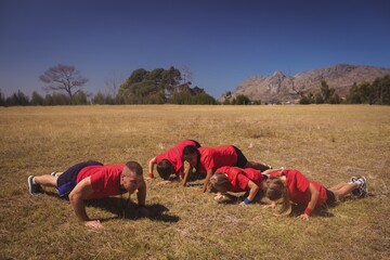 Wall Mural - trainer instructing kids while exercising in the boot camp