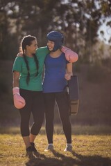 Wall Mural - Happy friends interacting with each other during obstacle course