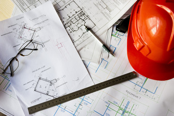 Construction helmet on the table with drawings sketches