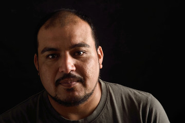 Portrait of a latin man on black background