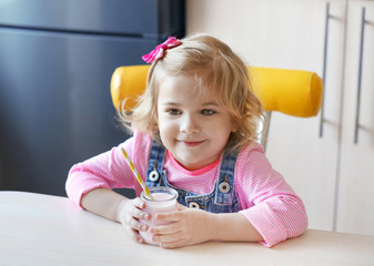 Poster - Cute little girl with yogurt at home