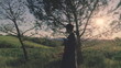 Young woman walking through Italian countryside at sunset