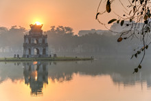 Sun Rising Behind The Turtle Tower In The Center Of Hoan Kiem Lake (Lake Of The Returned Sword). The Lake Is One Of The Major Scenic Spots In The City And Serves As A Focal Point For Its Public Life.