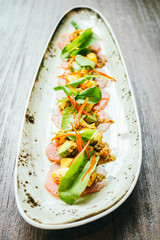 Poster - Raw fresh tuna fish meat salad with avocado and mango