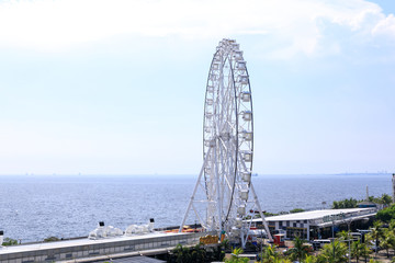 Wall Mural - May 31, 2017 Ferris wheel at Mall of Asia in Manila. The ferris wheel is situated near Manila Bay and is a popular attraction in the area