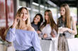 © spaskov - happy young woman talking on the phone in shopping mall