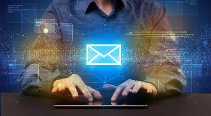 Businessman typing and mailing icon above