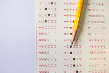 Wall Mural - yellow pencil on exam answer sheet, education test concept