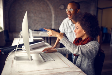 Poster - working woman in office consulting with co-worker