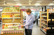© lado2016 - Man shopping in supermarket reading product information