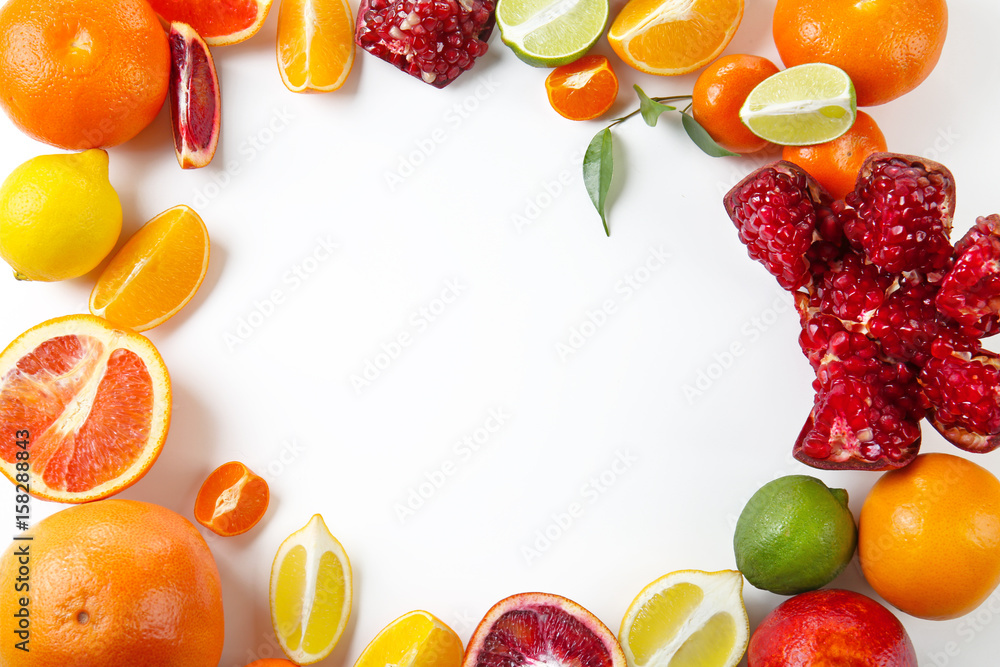 Composition of pomegranate and citrus fruits on white background