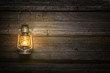 The old kerosene lamp on wooden background