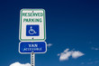 Reserved Handicapped Parking Sign with sky and clouds