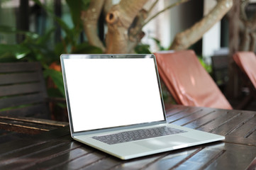 laptop computer white screen on table resort view background
