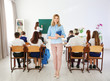 © Africa Studio - Female teacher with notebook in classroom