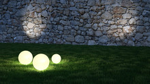 Glowing Spheres In Garden With Wall In Background