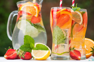 Wall Mural - mineral water with pieces of fruit in glass