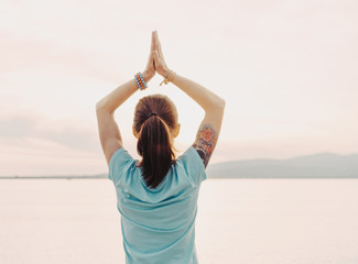 Wall Mural - Woman doing yoga on background of sea.