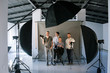 © Photodrive - Creative team posing in photo studio interior. Shot of art people looking at camera at the screen. End of hard work , photo for memory, friendship, crew concept