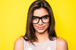 © F8  \ Suport Ukraine - Young girl wearing eyeglasses in yellow background. Girl looking at camera.