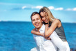 © Elena Kratovich - Happy couple on sea background. happy young romantic couple in love have fun on l beach at beautiful summer day