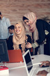 © FS-Stock - Two woman with hijab working on laptop in office.