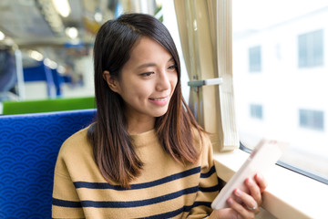 Canvas Print - Woman travel on train and use of cellphone