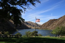 American Flag Waving Over River