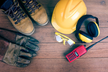 Top view of Standard construction safety equipment on wood background