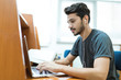 © torwaiphoto - Asian men are using a computer in a university library
