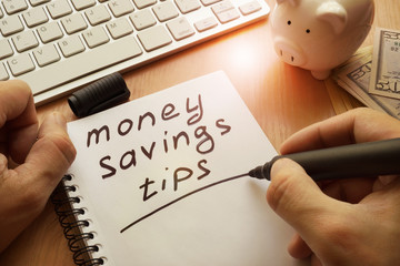 Wall Mural - Money saving tips written in a note.