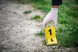 © Forance - Crime scene investigation, placing the crime scene marker on the ground