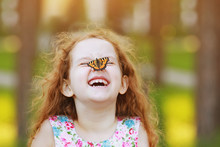 Laughing Funny Girl With A Butterfly On His Nose.