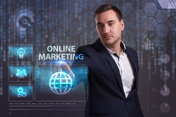 The concept of business, technology, the Internet and the network. A young entrepreneur working on a virtual screen of the future and sees the inscription: Online marketing