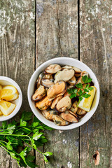 Wall Mural - Mussels with lemon and herbs. Shellfish seafood. Delicious snack for gourmands.Top view