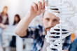 © Viacheslav Yakobchuk - Intelligent curious guy touching the model of enlarged genome